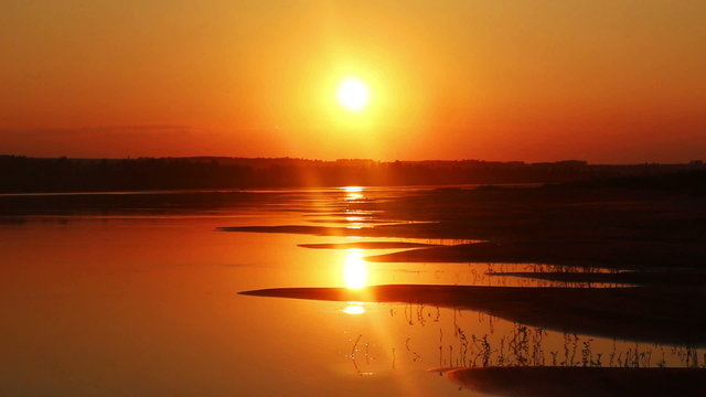 beautiful orange sunset with waved river sand beach