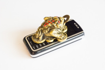 frog figurine with phone