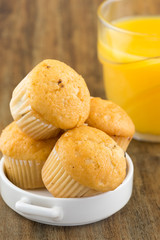 fresh chocolate chip muffins with a glass of orange juice