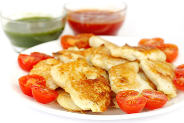Closeup of roasted fish with green and red sauce