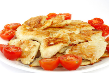 Closeup of roasted fish garnish with cherry tomato