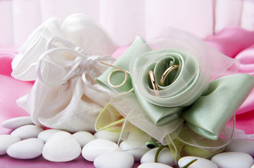  wedding rings and  favors on elegant  fabric