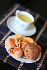Сookies, nuts, pastries and a cup of green tea