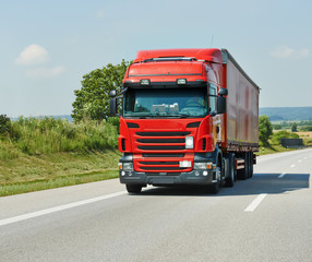 red lorry with trailer on highway