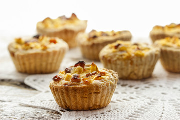 Homemade tart with dried fruits and fresh apples on white wooden