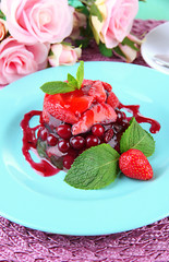 Tasty jelly dessert with fresh berries, on bright background