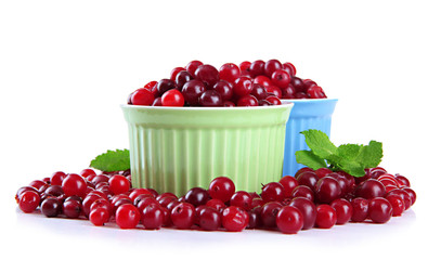 Ripe red cranberries in bowls, isolated on white.