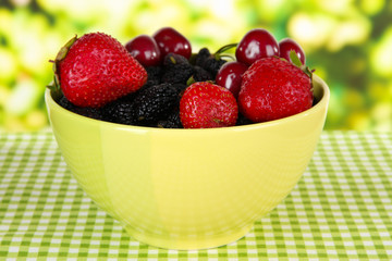 Ripe mulberries with cherry and strawberries in bowl