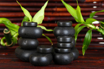 Spa stones and bamboo on bamboo mat background