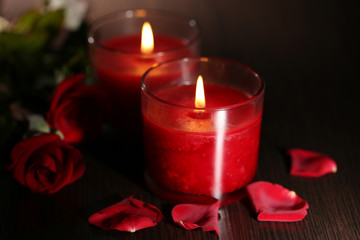 Beautiful romantic red candles with flower petals