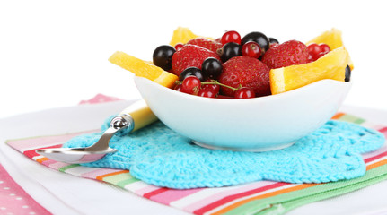 Useful fruit salad of fresh fruits and berries in bowl isolated