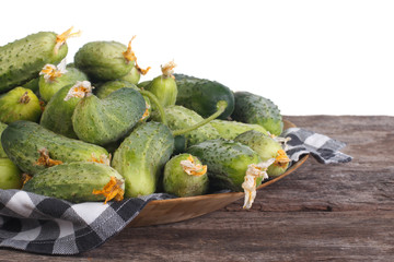Fresh cucumbers on a plate with a napkin on the table