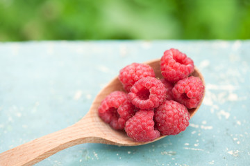 raspberries in wooden spoon