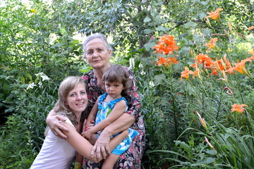 Family portrait in a garden, three generations