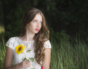 Naklejka premium Portrait of young attractive woman at summer green park.