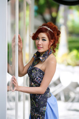 Beautiful young woman stand alone at the outdoor cafe