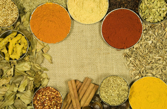 Herbs and spices on hessian background