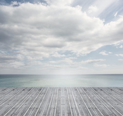 Wooden boards leading out to a bright horizon