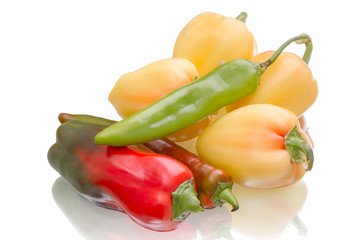 Sweet and hot peppers on white