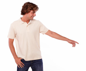 Charming young adult pointing to his left