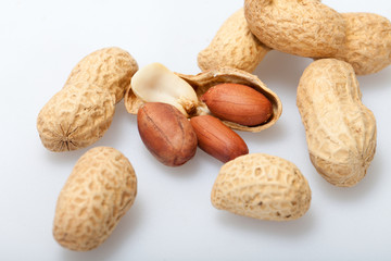 .Dried peanuts in closeup on the white background