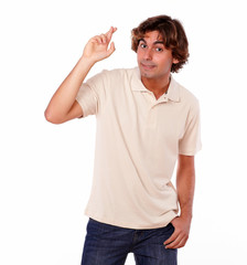 Attractive man crossing fingers while standing