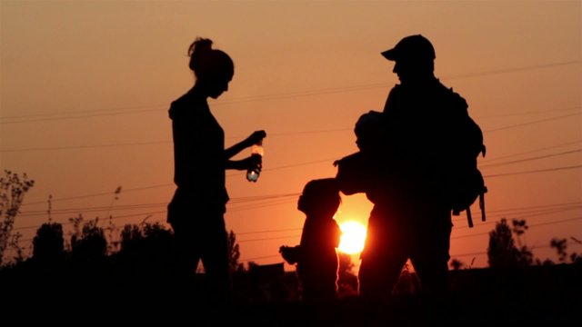 Young family on vacation at sunset,walk at sunset