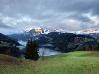 Cloudy sunrise over Dolomites mountains