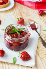 strawberry jam in a jar with mint