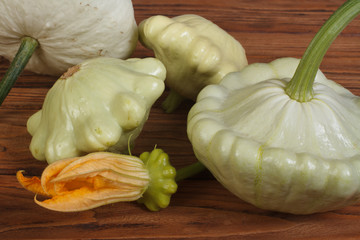 Ripe pattypan squash vegetables on a wooden brown table
