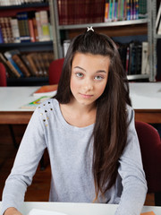 Portrait Of Female Student Sitting In Library