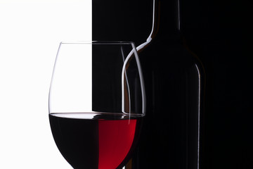 Elegant symmetry red wine glass and a wine bottle
