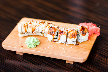 Sushi rolls served on a wooden plate