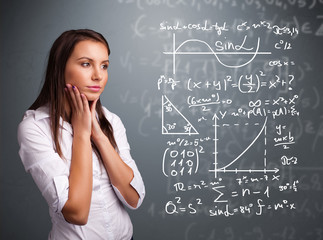 Beautiful school girl thinking about complex mathematical signs