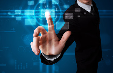 Businessman pressing high tech type of modern buttons
