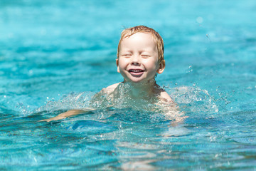 Three year old boy in swimming pool