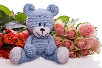 blue teddy bear with pink roses