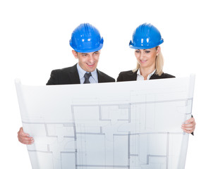 Two Architects Looking At Blueprint