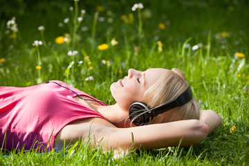 Young Woman Lying On Grass