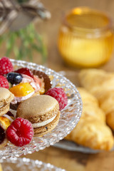 Parisian macarons, raspberries and other delicacy. Closeup