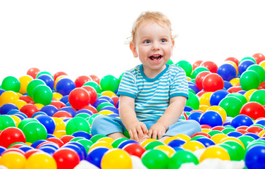 Fototapeta na wymiar Happy kid playing colorful balls