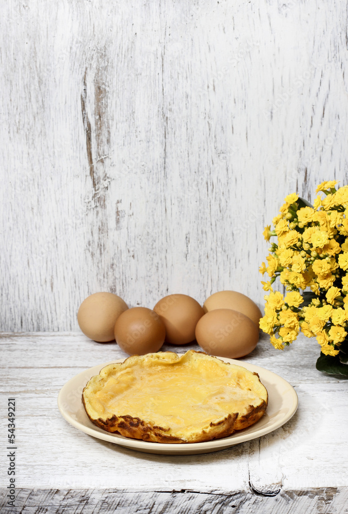 Canvas Prints omelette on white wooden table, eggs in the background