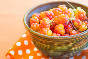 Cloudberries on orange napkin