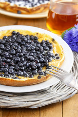 Omelette with blueberries on grass. Garden party, summer food