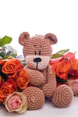 brown teddy bear with red roses