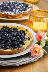Omelette with blueberries on wooden table. Romantic summer set