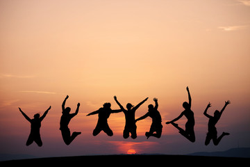 silhouette of friends jumping in sunset - 54351405