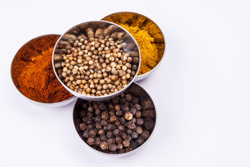 Curry, pepper,  paprika and coriander - white background.