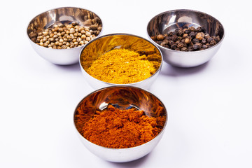 Curry, pepper,  paprika and coriander - white background.