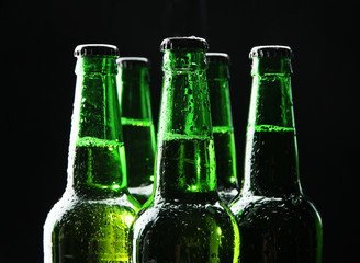 Bottles of beer on black background